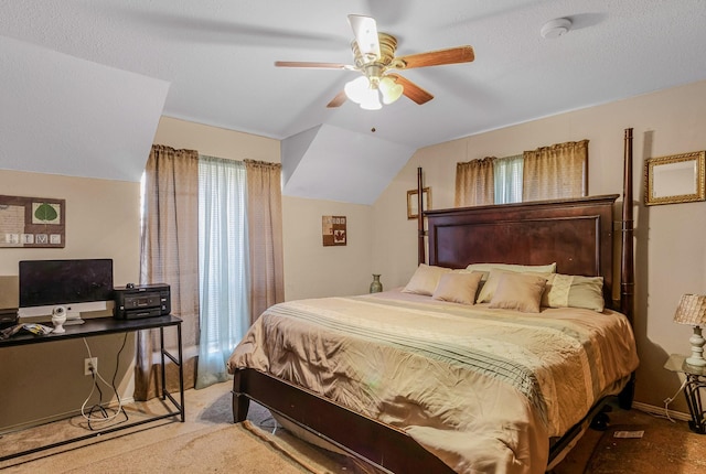 bedroom featuring lofted ceiling, a textured ceiling, ceiling fan, and carpet flooring