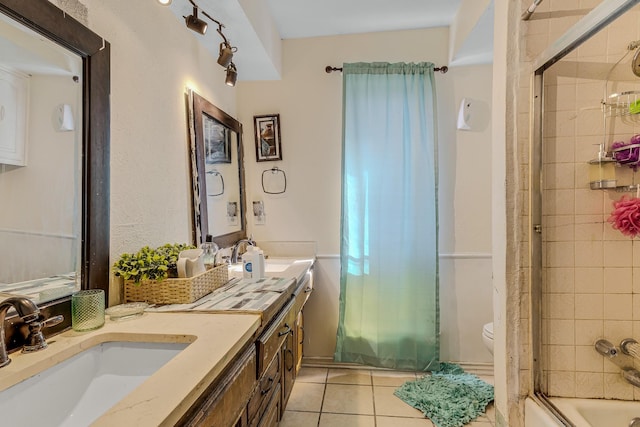 full bathroom with vanity, combined bath / shower with glass door, tile patterned floors, and toilet