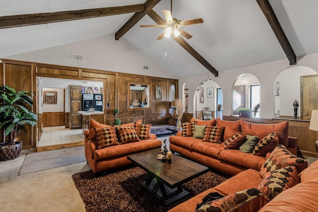 living room with beamed ceiling, ceiling fan, light carpet, and high vaulted ceiling