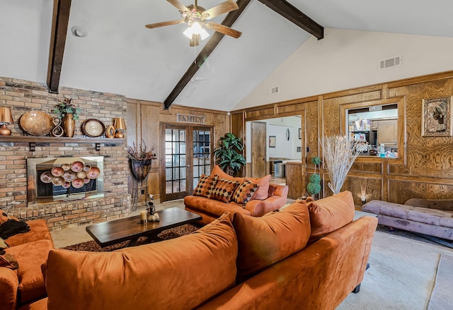 carpeted living room featuring ceiling fan, beam ceiling, high vaulted ceiling, a brick fireplace, and french doors