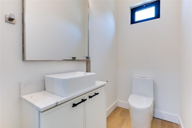 bathroom featuring vanity, toilet, and wood-type flooring