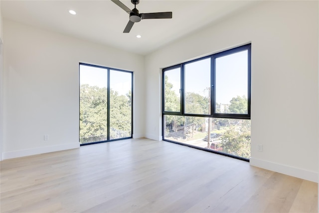 empty room with ceiling fan and light wood-type flooring