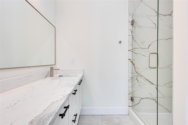 bathroom with vanity, a shower with shower door, and tile patterned floors