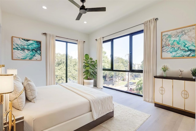 bedroom featuring ceiling fan and light hardwood / wood-style flooring