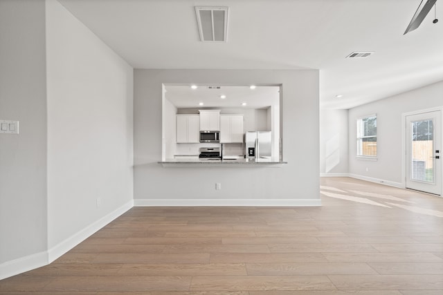 unfurnished living room featuring light hardwood / wood-style floors