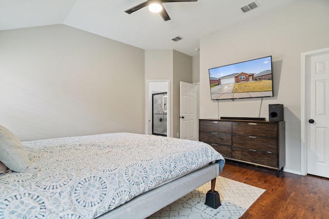 bedroom with vaulted ceiling, dark wood-style flooring, visible vents, and a ceiling fan