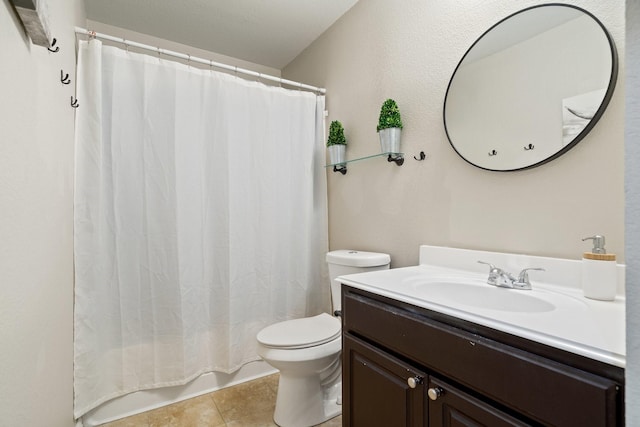 bathroom featuring tile patterned flooring, shower / tub combo with curtain, vanity, and toilet