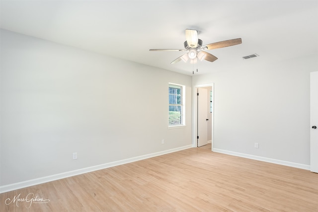 empty room with ceiling fan and light hardwood / wood-style floors