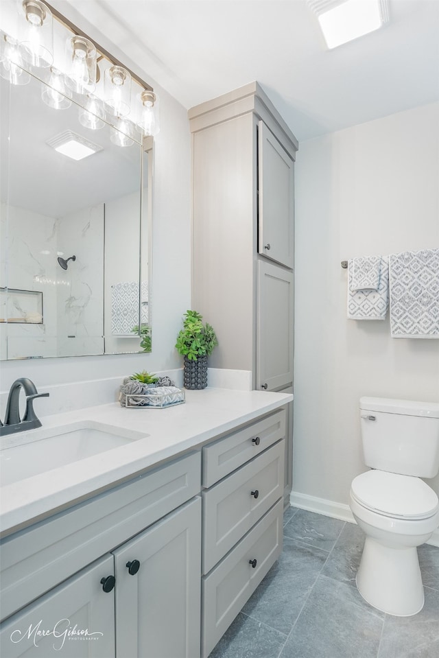 bathroom featuring vanity, toilet, and a shower