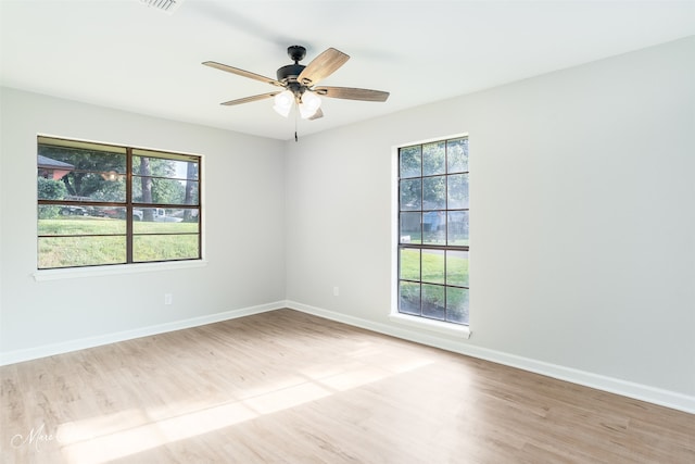 empty room featuring ceiling fan and light hardwood / wood-style flooring