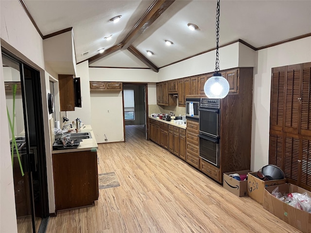 kitchen featuring appliances with stainless steel finishes, decorative light fixtures, vaulted ceiling with beams, dark brown cabinetry, and light wood-type flooring