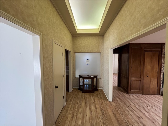 hall featuring wallpapered walls and light wood-style floors