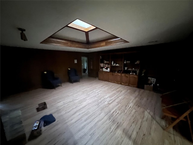 additional living space featuring light hardwood / wood-style flooring and a skylight