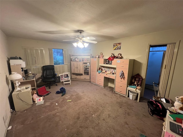 game room featuring ceiling fan and a textured ceiling