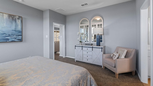 bedroom with dark colored carpet