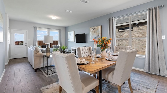 dining space with wood-type flooring