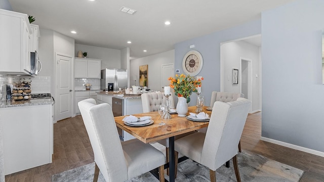 dining space with dark wood-type flooring