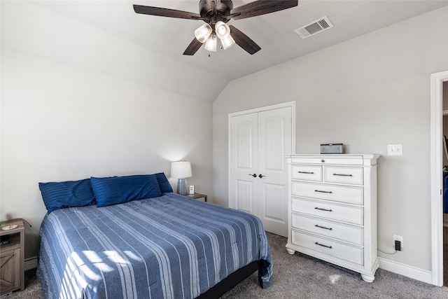 bedroom featuring lofted ceiling, dark carpet, a closet, and ceiling fan