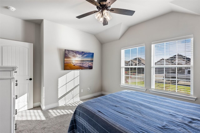 bedroom featuring multiple windows, carpet floors, ceiling fan, and vaulted ceiling