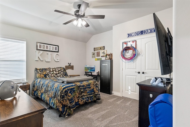 bedroom featuring ceiling fan, lofted ceiling, carpet flooring, and a closet