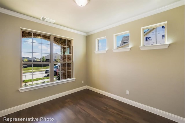 empty room featuring crown molding and dark hardwood / wood-style flooring