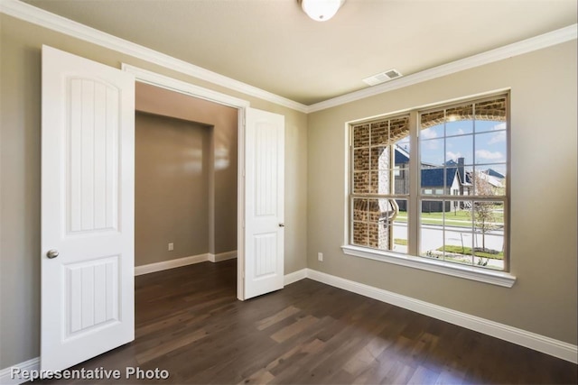 unfurnished bedroom featuring crown molding and dark hardwood / wood-style flooring