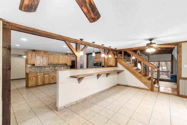 kitchen with a breakfast bar, decorative backsplash, light tile patterned flooring, decorative light fixtures, and kitchen peninsula