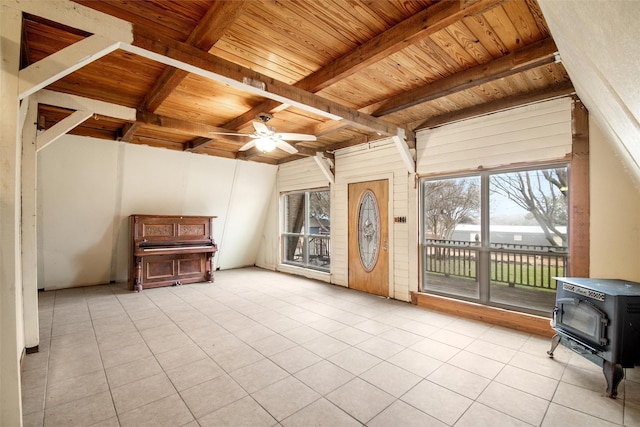 unfurnished living room featuring light tile patterned floors, wooden ceiling, beamed ceiling, and a wood stove