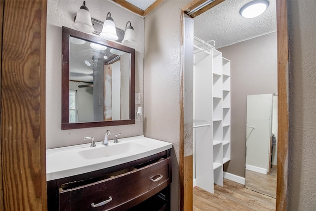 bathroom with vanity, hardwood / wood-style floors, and a textured ceiling