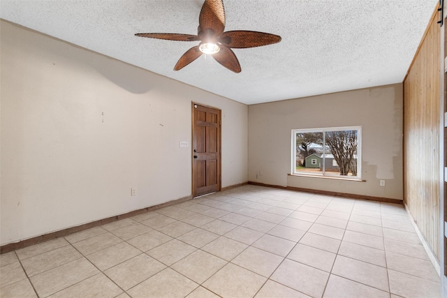 unfurnished room with light tile patterned flooring, ceiling fan, and a textured ceiling