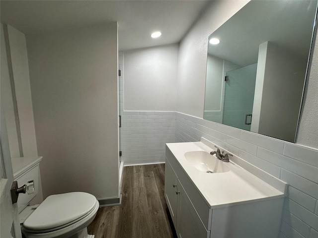 bathroom featuring tile walls, vanity, an enclosed shower, wood-type flooring, and toilet