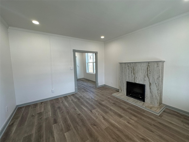 unfurnished living room with dark hardwood / wood-style flooring, crown molding, and a high end fireplace