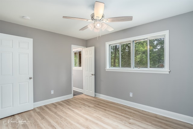 unfurnished bedroom with ceiling fan and light wood-type flooring