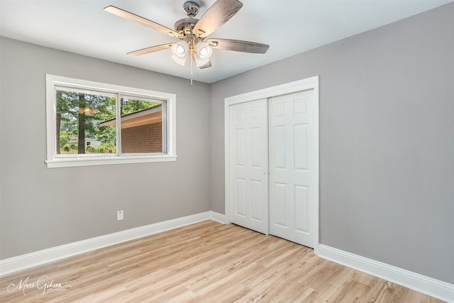 unfurnished bedroom featuring light hardwood / wood-style flooring, a closet, and ceiling fan