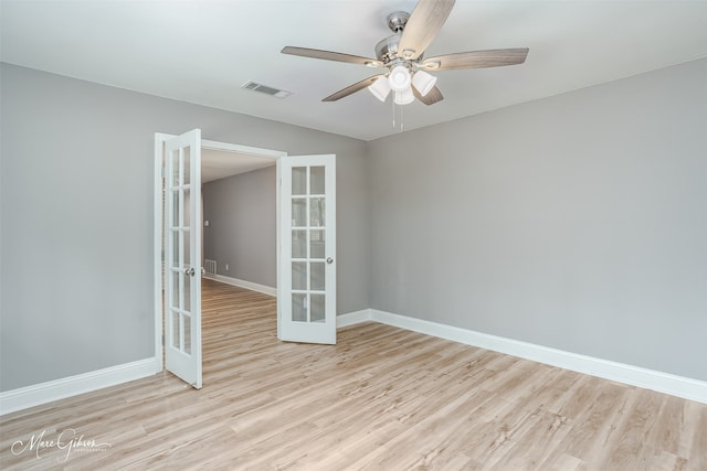 unfurnished room featuring ceiling fan, light wood-type flooring, and french doors