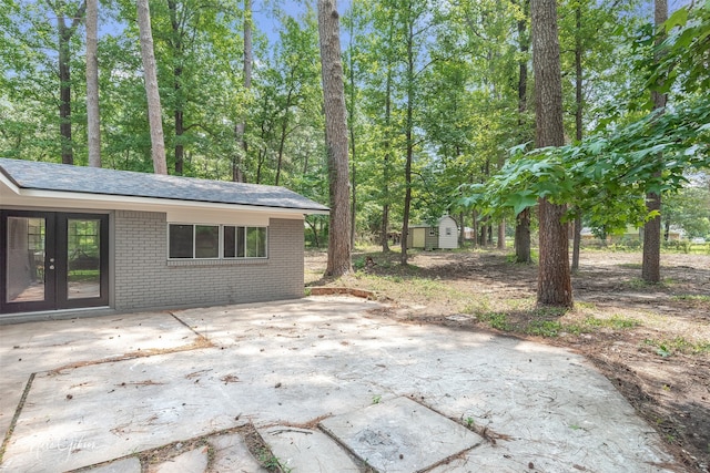 view of patio featuring french doors and a storage unit