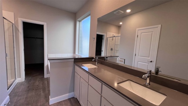 bathroom featuring vanity, hardwood / wood-style floors, and a shower with door