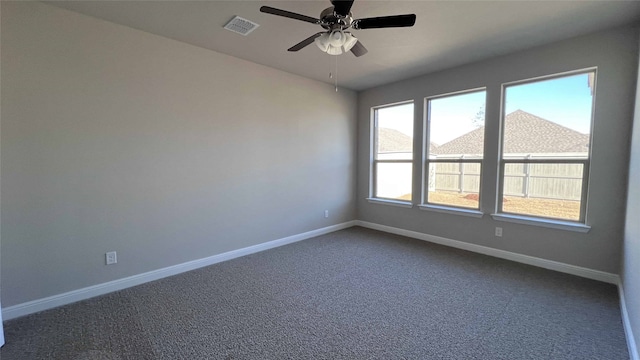 unfurnished room featuring ceiling fan and dark carpet