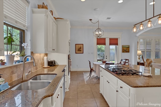 kitchen featuring white cabinetry, sink, dark stone counters, and stainless steel gas cooktop