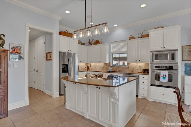 kitchen featuring white cabinetry, a center island, dark stone countertops, and appliances with stainless steel finishes