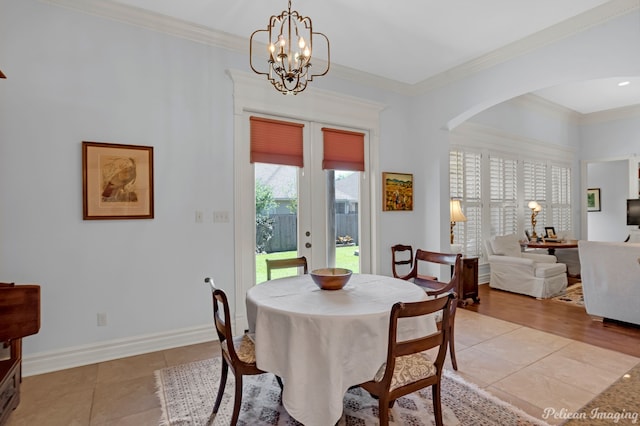 dining space with french doors, ornamental molding, and light tile patterned floors