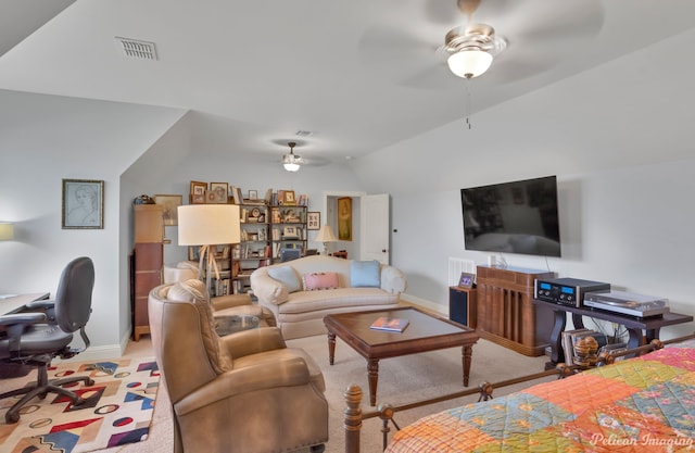 carpeted living room featuring ceiling fan and vaulted ceiling