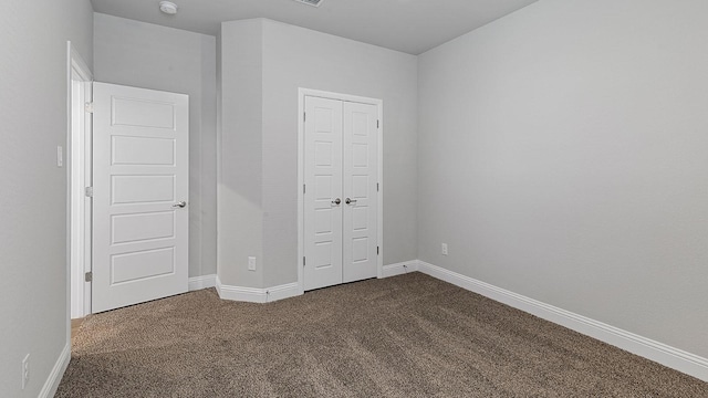 unfurnished bedroom with carpet floors and a closet