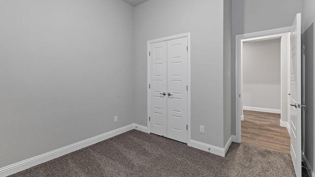 unfurnished bedroom featuring dark carpet