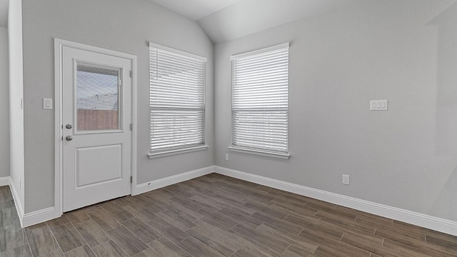 empty room with wood-type flooring and vaulted ceiling