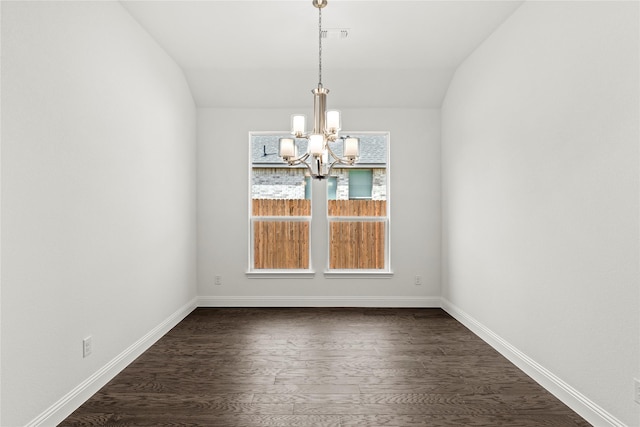 unfurnished dining area with dark hardwood / wood-style flooring, vaulted ceiling, and a notable chandelier