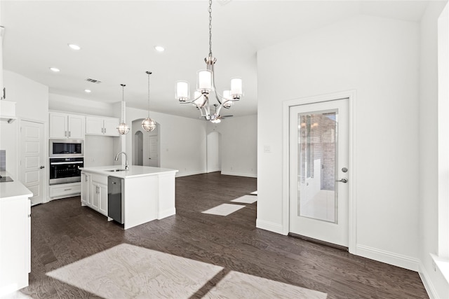 kitchen with pendant lighting, sink, white cabinetry, stainless steel appliances, and a center island with sink