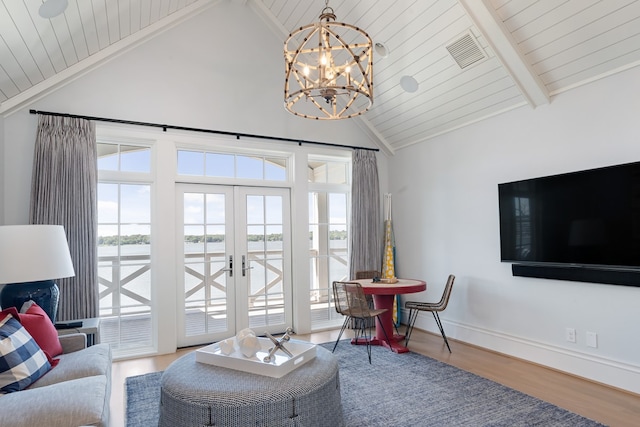 living room with hardwood / wood-style flooring, beamed ceiling, french doors, and a wealth of natural light