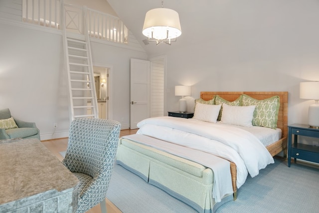 bedroom featuring hardwood / wood-style flooring and high vaulted ceiling