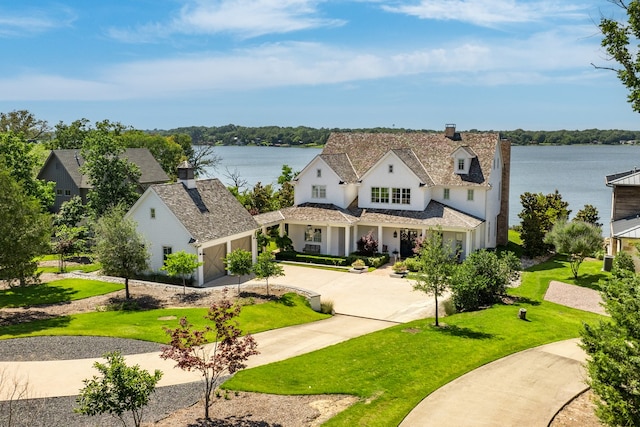 view of front facade with a water view and a front yard